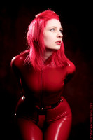 Photo of Ulorin in a chastity belt and red latex catsuit